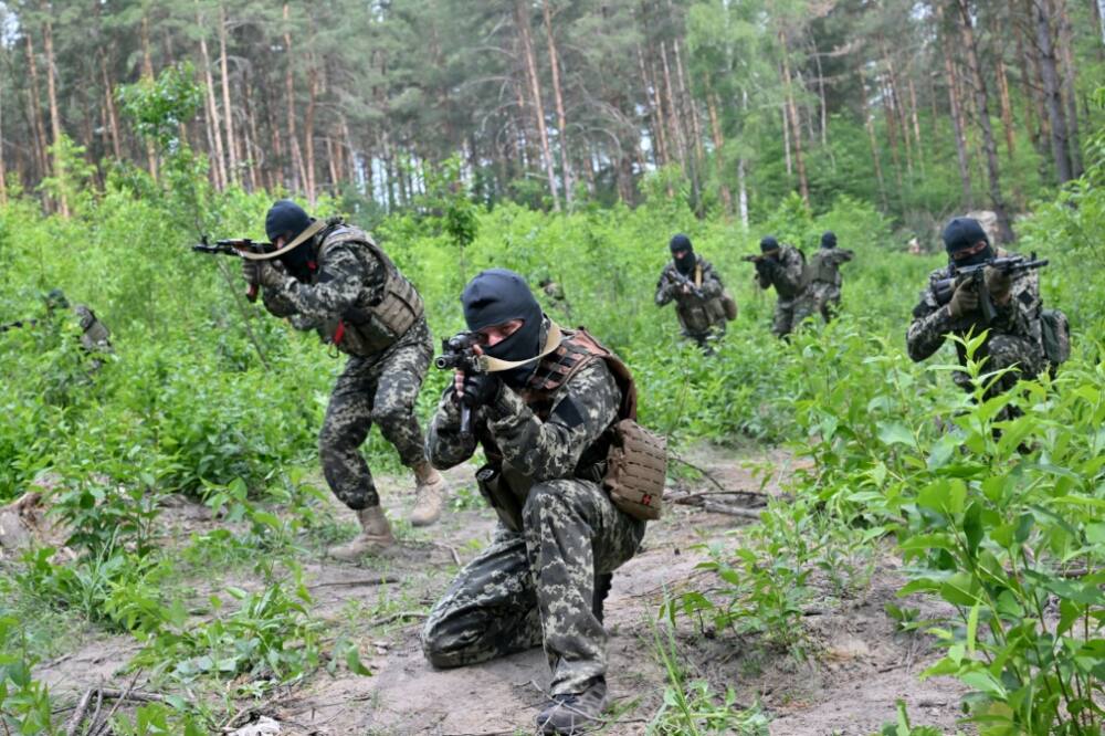 Fighters of Ukraine's territorial defense unit that supports the regular army take part in an exercise near the town of Bucha on June 17, 2022