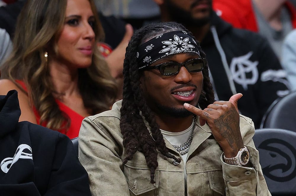 Quavo poses for a picture during the third quarter between the Atlanta Hawks and the Charlotte Hornets at State Farm Arena