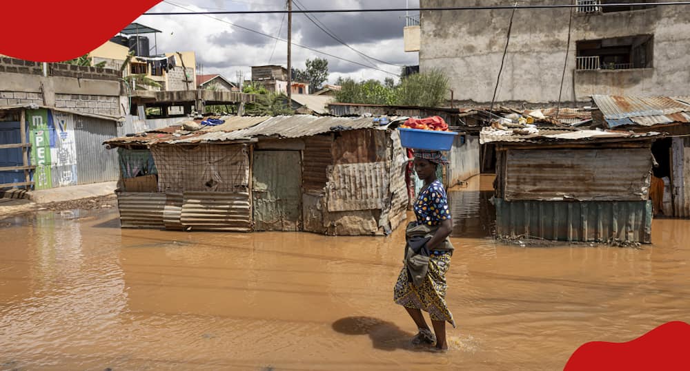 Nairobi resident walks through a flooded path.