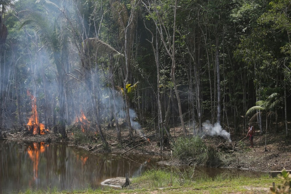 A man lights a fire on the edge of the Transamazonica highway in Manicoré, Amazonas state, Brazil, on September 23, 2022