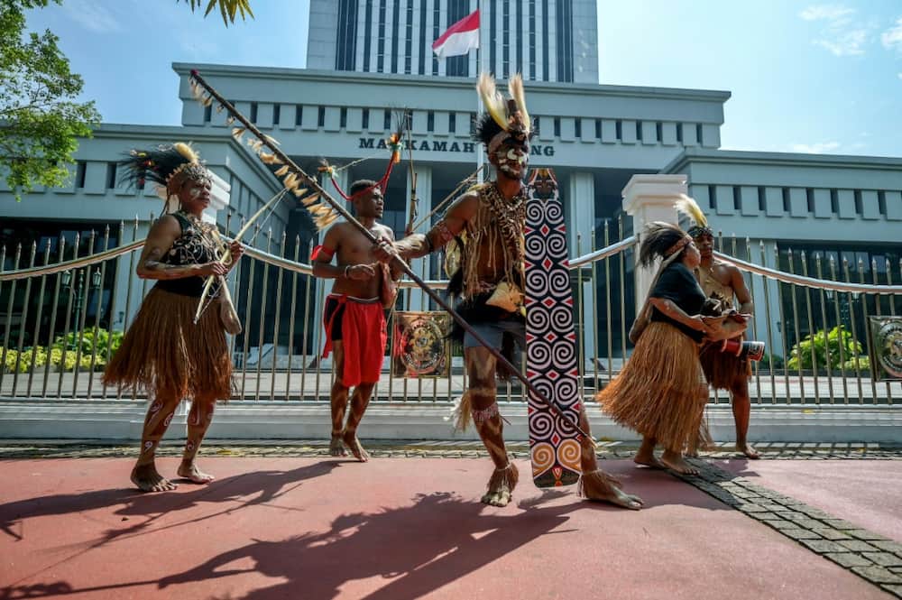 Representatives of the Awyu and Moi Indigenous tribes protest in front of Indonesia's Supreme Court