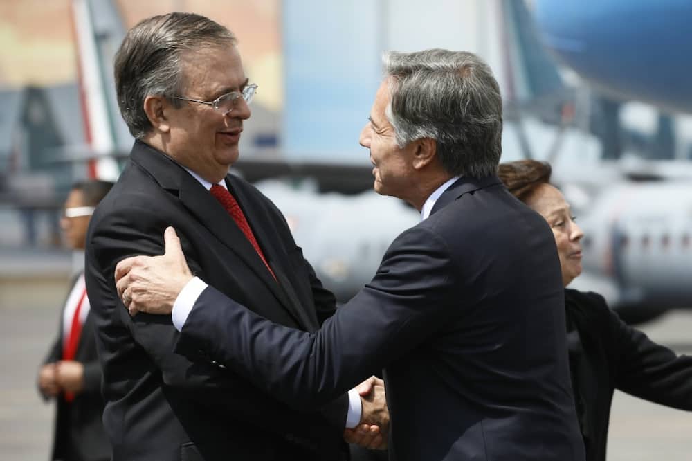 Blinken (R) greets Mexican Foreign Minister Marcelo Ebrard as the top US diplomat arrives in Mexico City on September 12, 2022