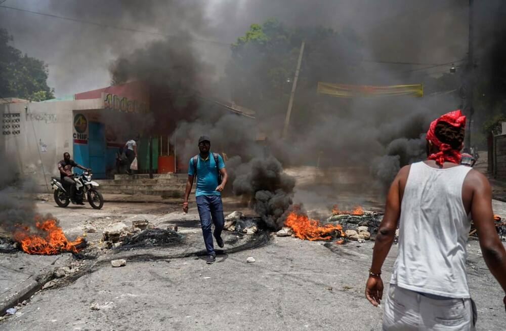 Haitians protesting high prices and shortages burn tires on a street of Port-au-Prince on July 13, 2022