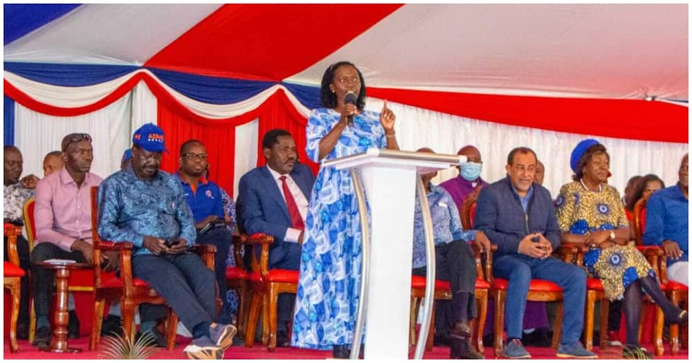 Lady in blue addressing gathering.