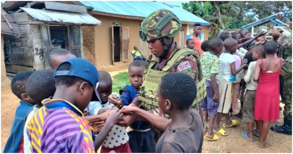 A KDF female soldier interacting with kids at Eringeti area in Eastern DRC. Photo: KDF.