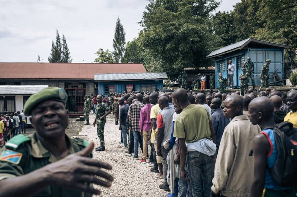 Hundreds of volunteers line up near a military base in Goma for army training