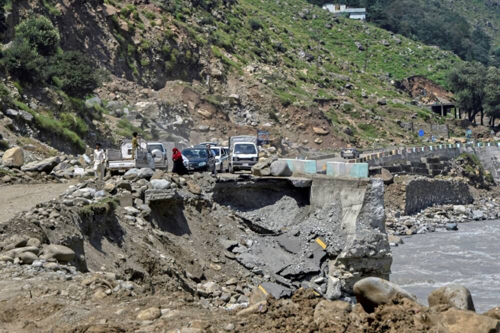 Vehicles wait to pass on a badly damaged road near  Bahrain in Swat. The road ends short of the town after a flash flood destroyed its main bridge