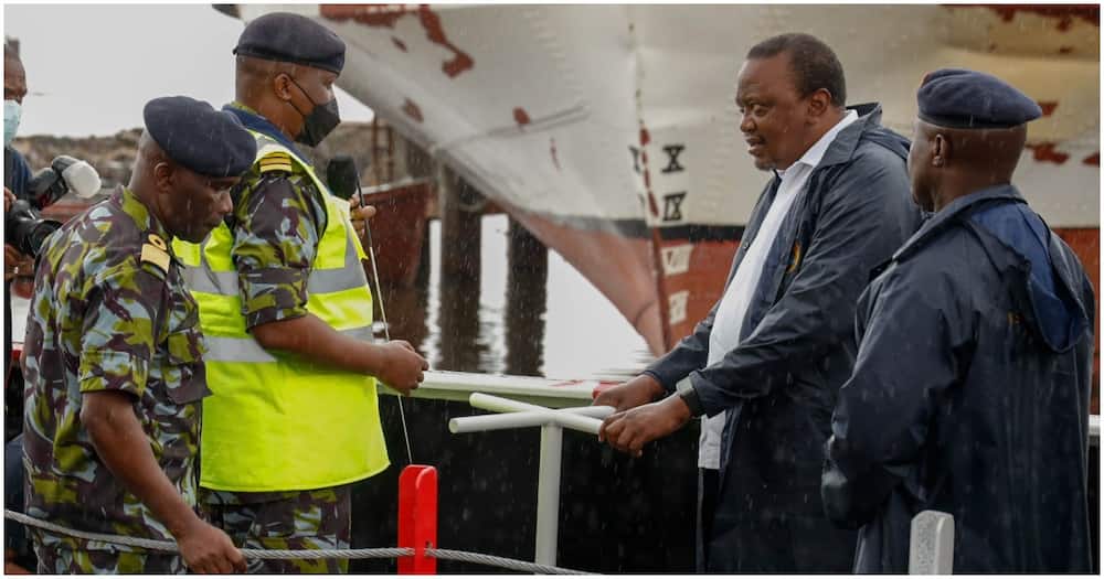 Kenya Navy officer explaining something to Uhuru Kenyatta