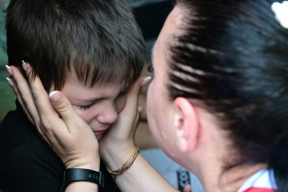 A woman says goodbye to her son before his evacuation from the city of Sloviansk on Wednesday