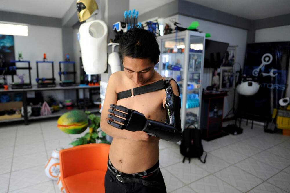 Marco Antonio Nina, 26, who lost his left arm at the age of 14 in a work accident, tests his bionic arm prosthesis that Roly Mamani made for him in his'Robotics Creators' workshop in Achocalla, Bolivia, on January 8, 2024