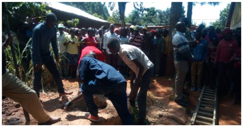 Curious onlookers surround a well where human remains were found.