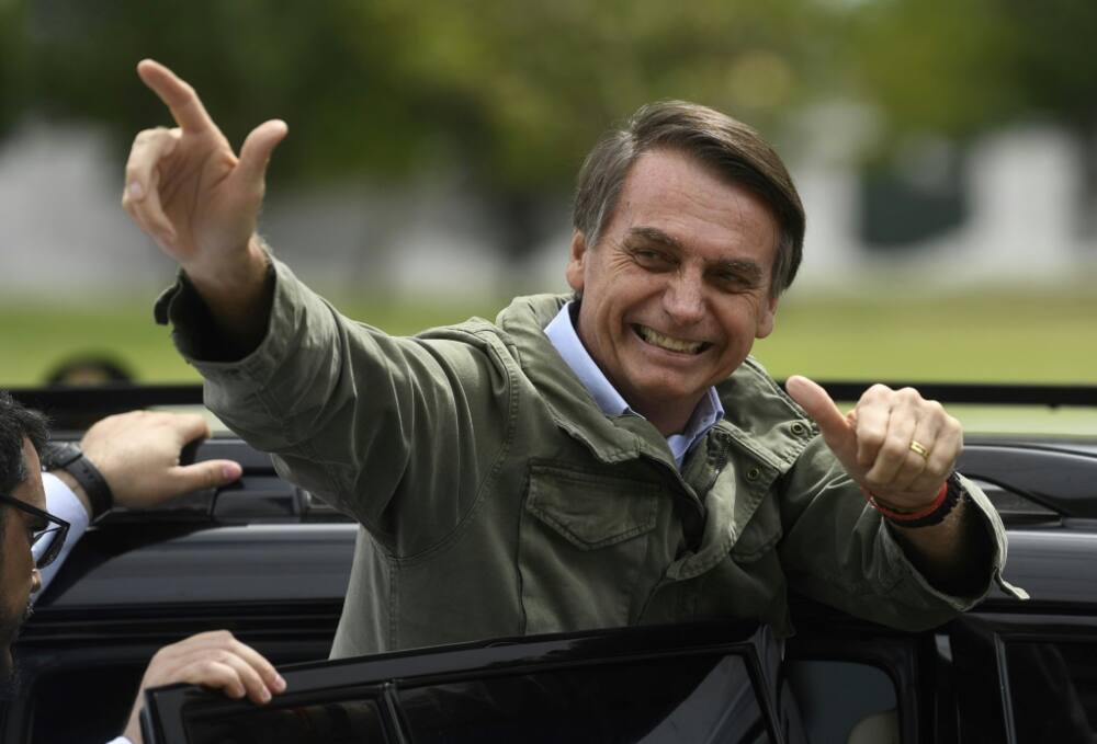 Jair Bolsonaro, far-right lawmaker and former amry officer, gives thumbs up to supporters in October 2018 during the second round of presidential elections, in Rio de Janeiro, Brazil