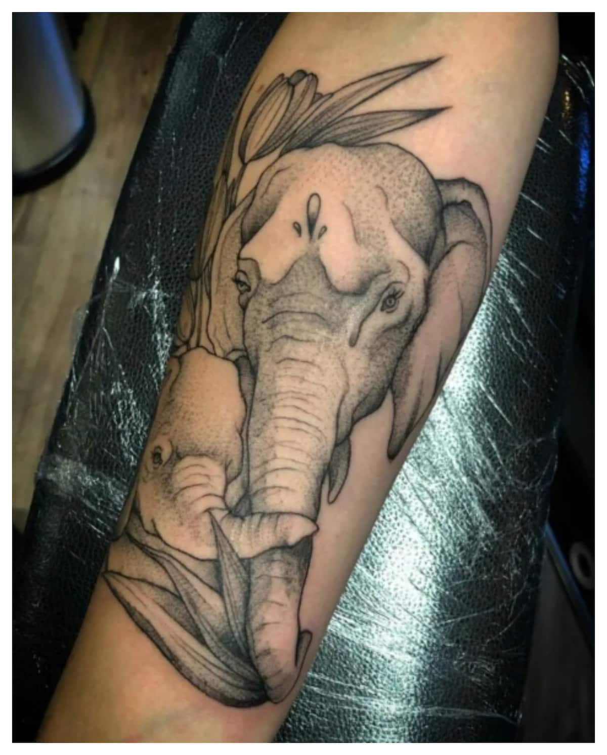 Elephant and galaxy tattoo located on the ankle.