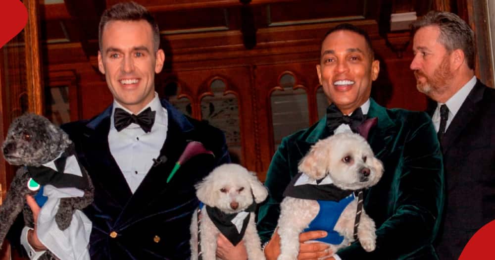 Don Lemon and Tim Malone (both in matching tuxedos) holding their three dogs after wedding.