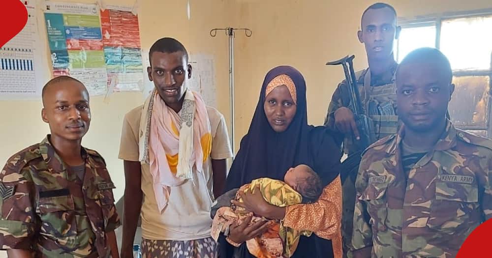 KDF officers with a newborn baby.