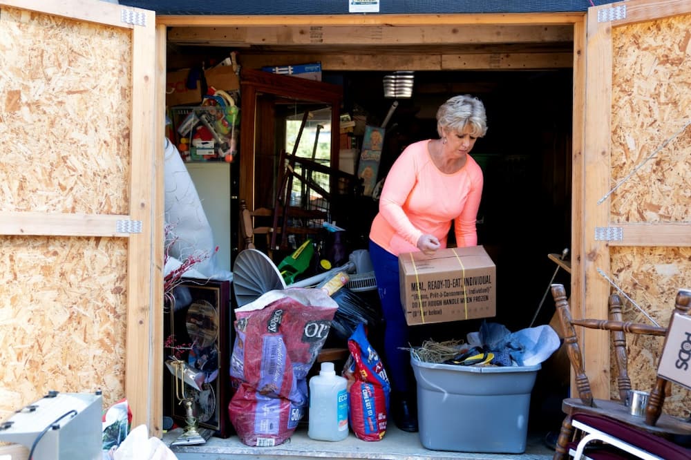 Christy White salvages items from a shed outside her flooded home in Lost Creek, Kentucky,  September 29, 2022