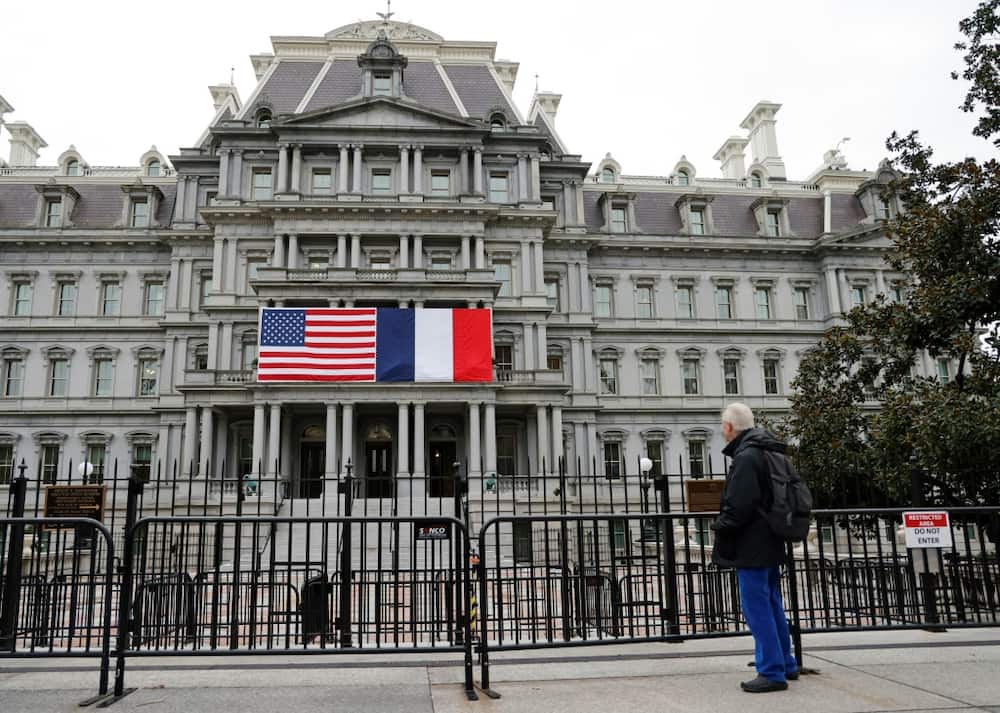 French and US flags adorn the Eisenhower Executive Office Building next to the White House for the state visit of French President Emmanuel Macron who arrives in Washington on November 29, 2022