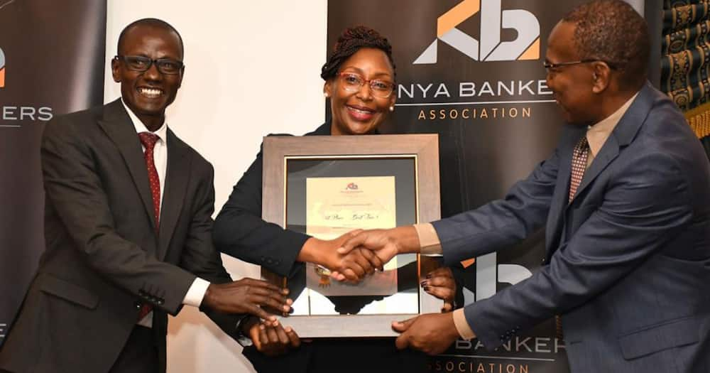 Co-op Bank's duo Chris Cheruiyot (l) and Rose Nyamweya (c) receive certificate of Overall Winner of Customer Satisfaction awards of Kenya Bankers’ Association from KBA Communications and Public Affairs Director Fidelis M. Muia.