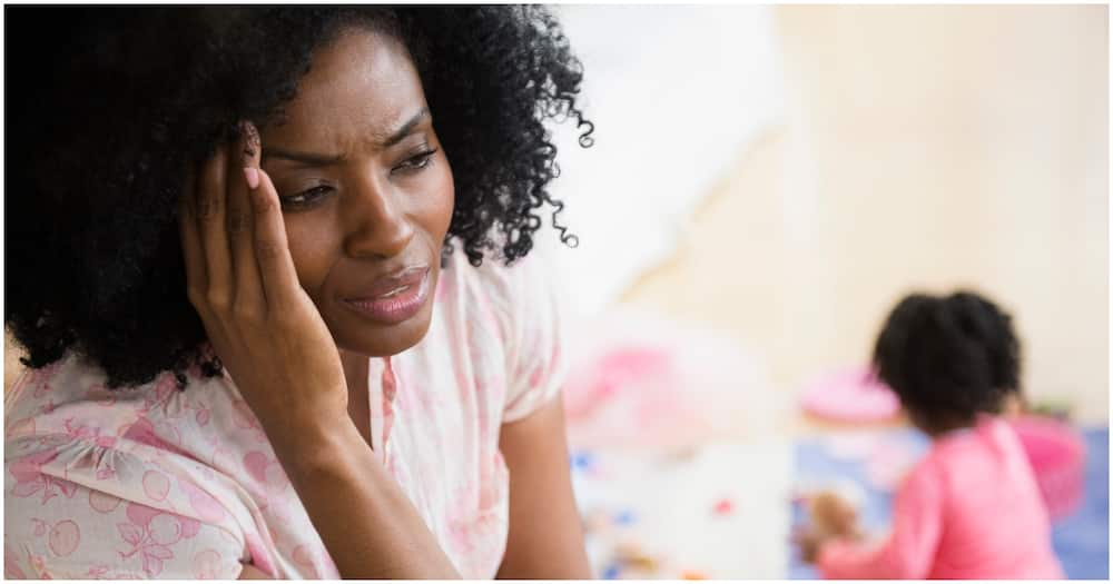 Frustrated mother rubbing her temples. Photo: Getty Images.