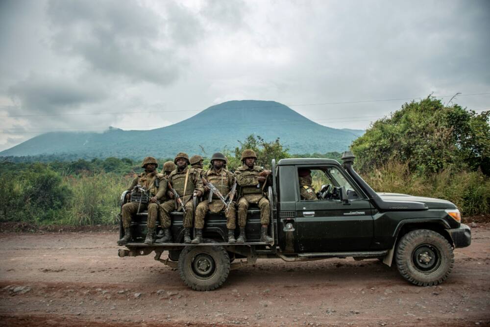 A Congolese army pick up carrying troops heads towards the front line near Kibumba in the area surrounding the North Kivu city of Goma on May 25, 2022, during clashes between the Congolese army and M23 rebels