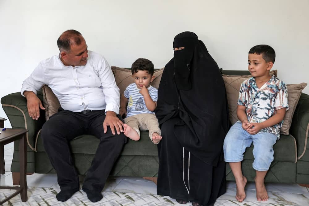 Moatassem Abdel Sater, a 42-year-old former inmate at Sednaya prison, with his wife Bara'ah and their children Othman, on the left, and Abdel Sattar