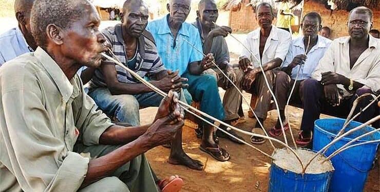 Teso elders drinking busaa during a ceremony
