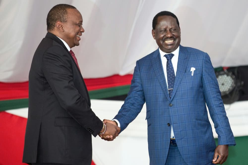 Friends: Kenyatta, left, and Odinga press the flesh at a prayer breakfast in May 2018