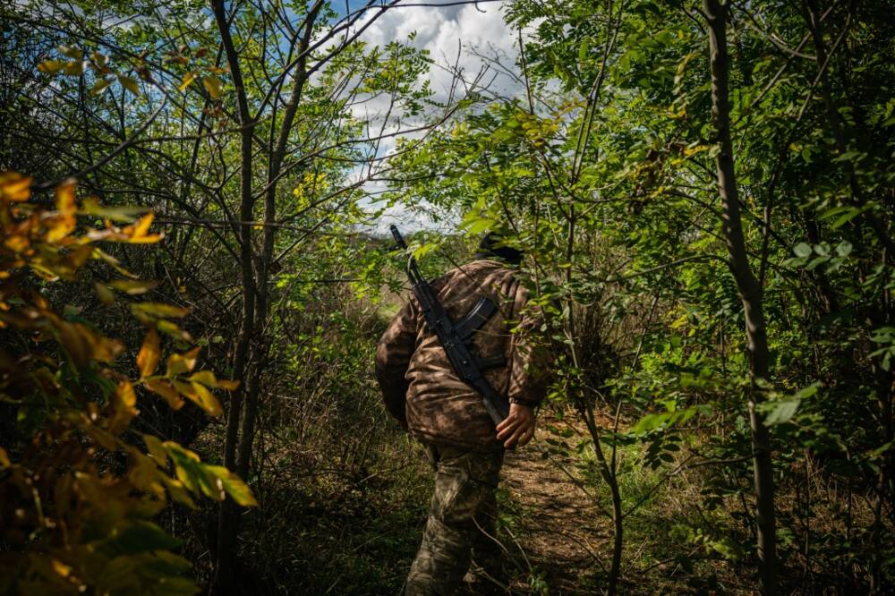 A Ukrainian soldier patrols at a position along the front line in the Mykolaiv region