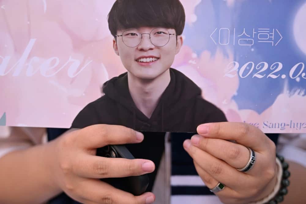 A fans shows off memorabilia of South Korea’s eSports player Lee Sang-hyeok, also known as Faker