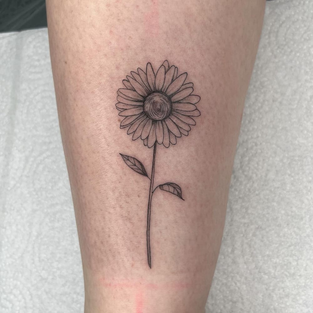 A black painted single daisy on the arm