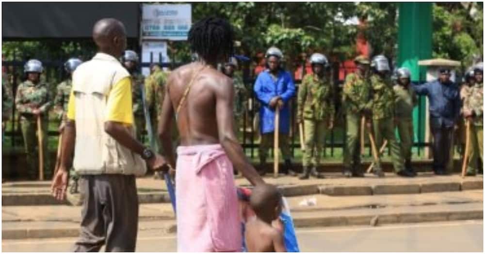 Kisumu man demonstrating with son. Photo: Nation.