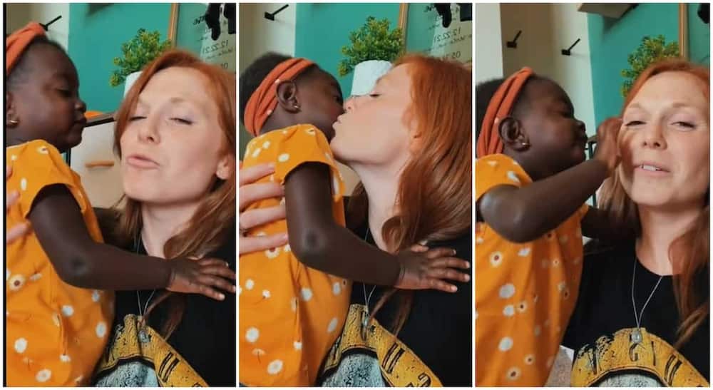 Photos of a white woman plaing with her adopted black kid.
