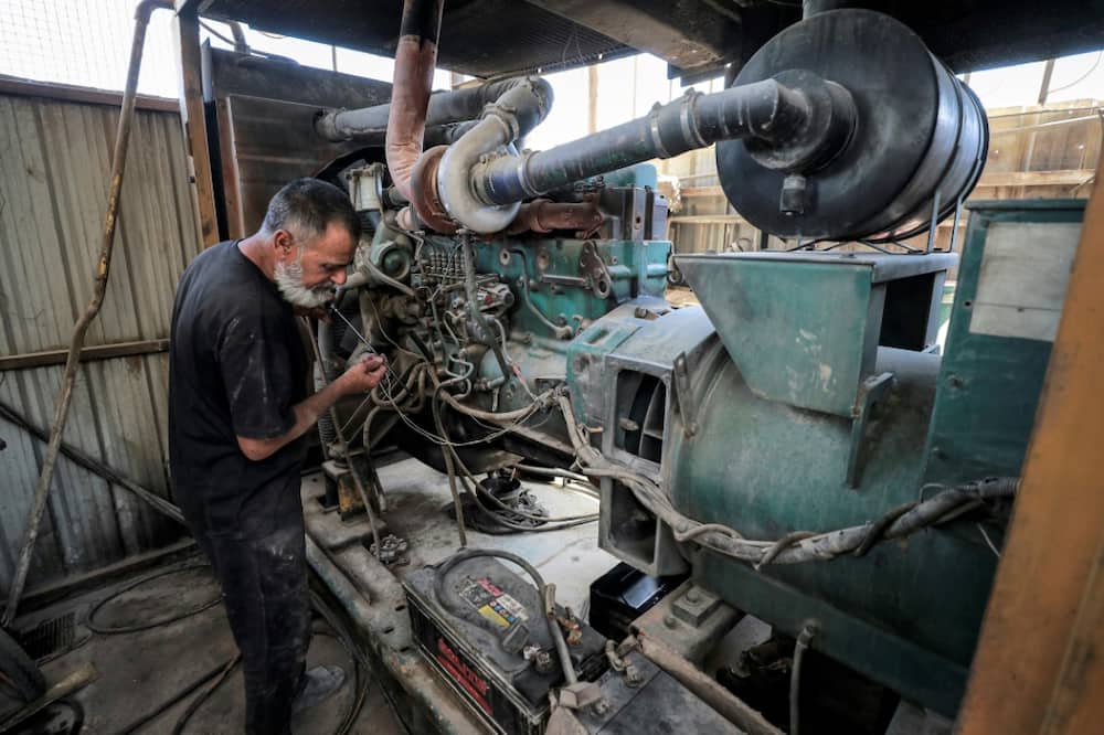A technician checks the oil levels of a generator in Baghdad's Sadr City. The noise of privately owned generators can be heard all over Iraq as households and businesses make up for shortfalls in the national supply