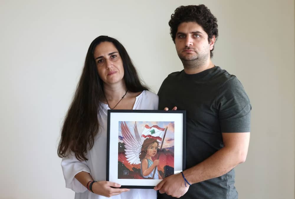 Paul and Tracy Naggear hold a framed drawing for their late daughter Alexandra, who was killed in the Beirut port blast of August 2020