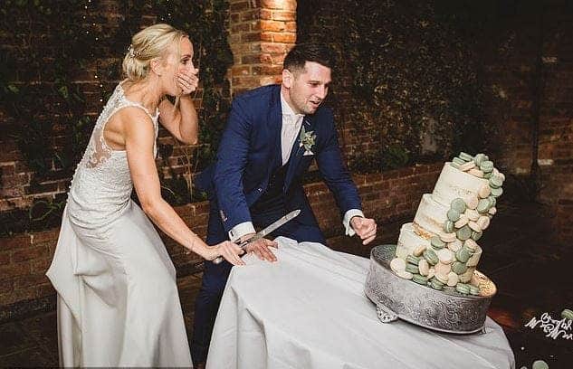 Couple watch in horror as the table holding their N250k wedding cake collapses