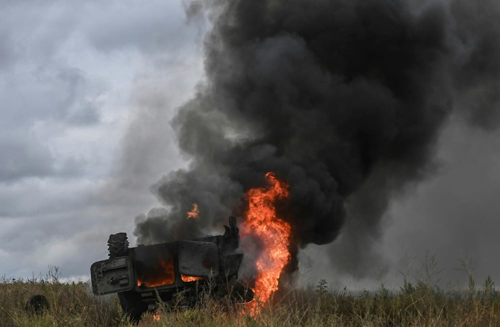 A military vehicle burns outside of the Izyum, a city recaptured by Ukraine troops