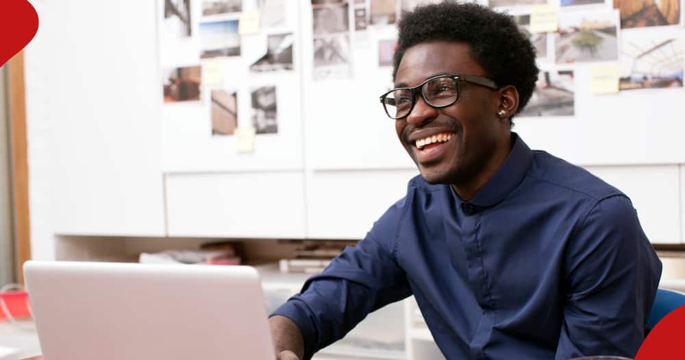 A young man smiles at an office.