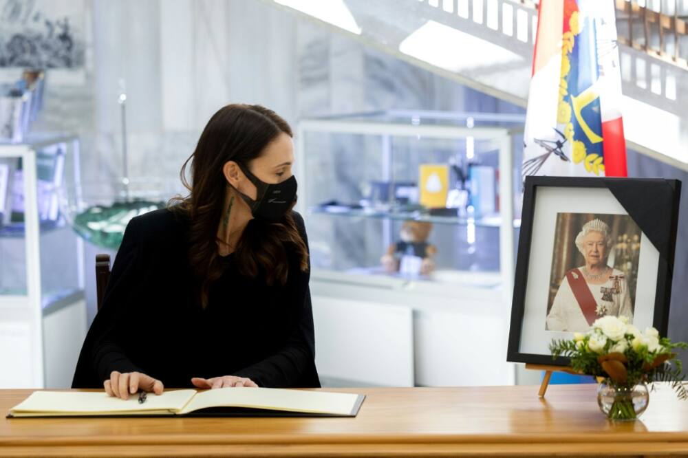 New Zealand Prime Minister Jacinda Ardern writes in a condolence book for Britain's Queen Elizabeth II in Wellington on Friday