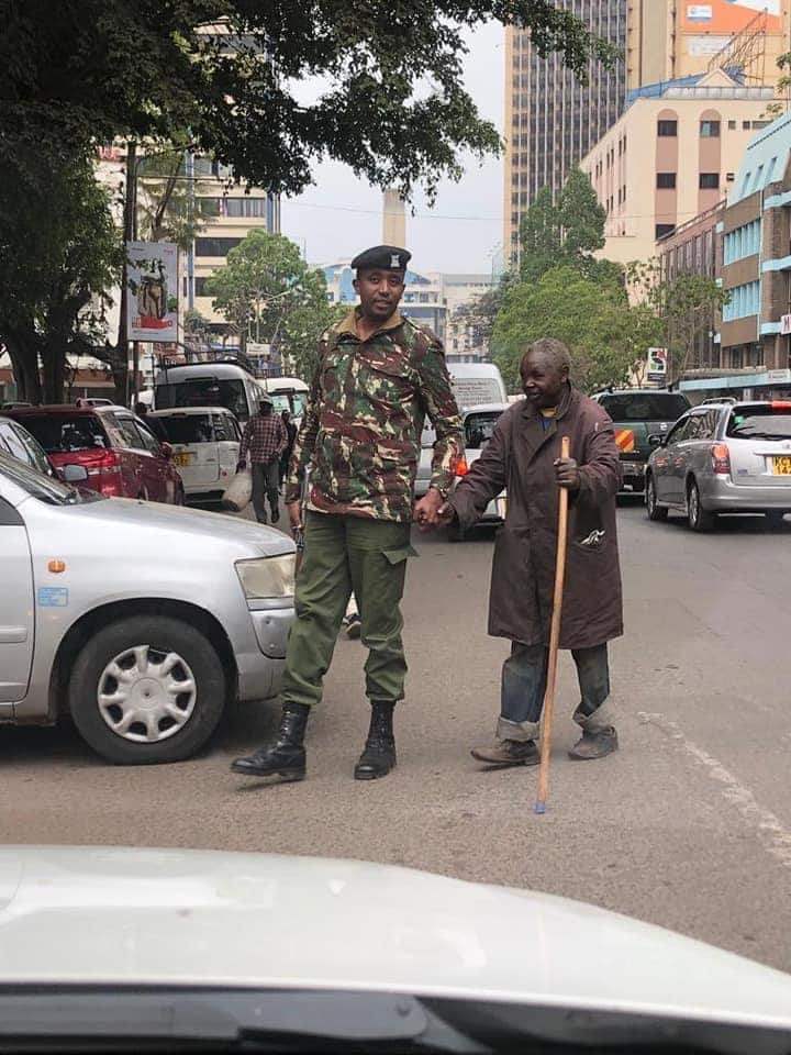 Photos of Nairobi police officer helping blind man cross road warms hearts online