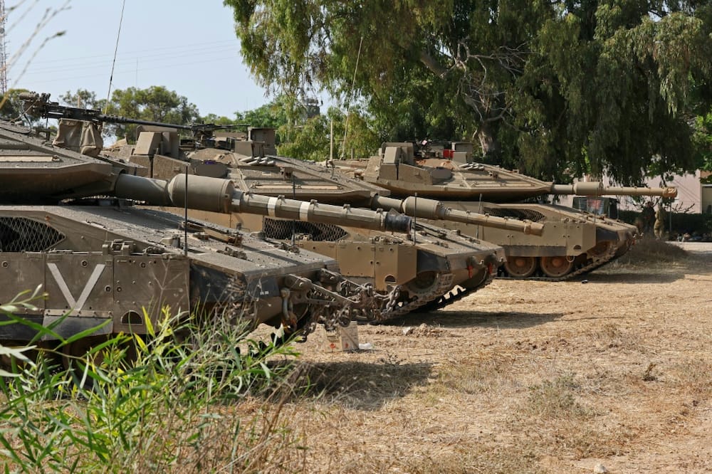 Israeli tanks deploy along the Gaza border as the army places more restrictions on the movement of Israeli civilians in communities nearby