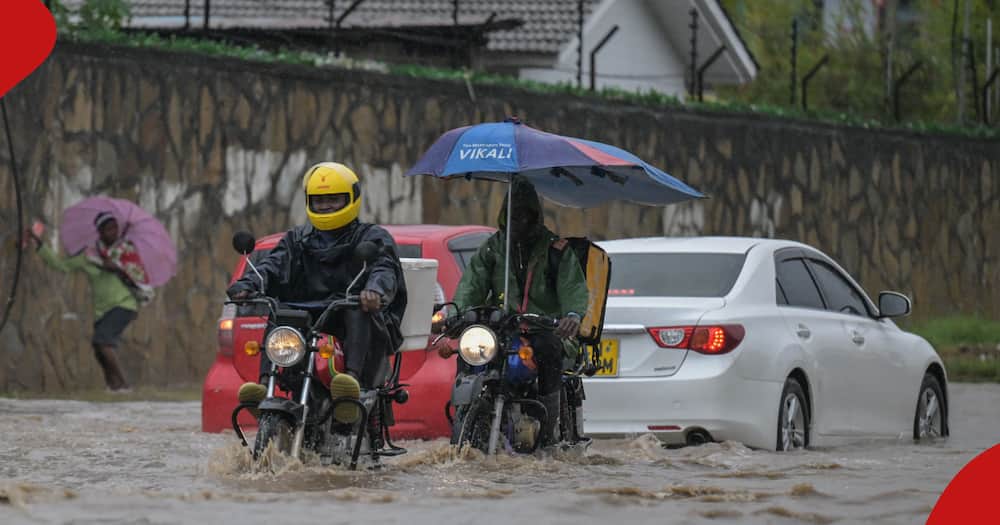 Boda boda operators riding on flooded road.