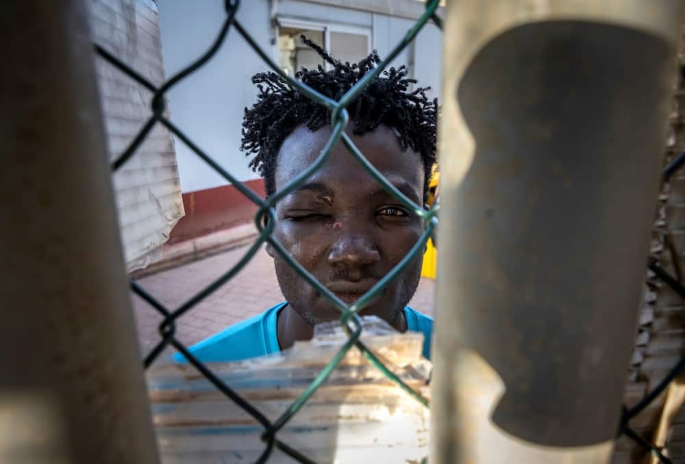 A Sudanese migrant with an eye injury waits in a temporary centre for migrants and asylum seekers in the Spanish enclave of Melilla