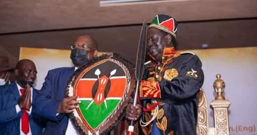 Raila posing with a shield.