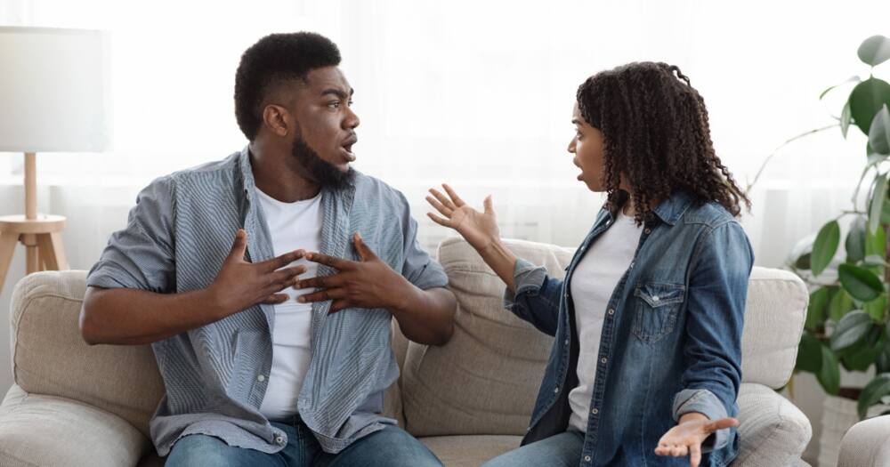 Jealous African wife blaming husband for infidelity during a quarrel at home. Photo: Getty Images.