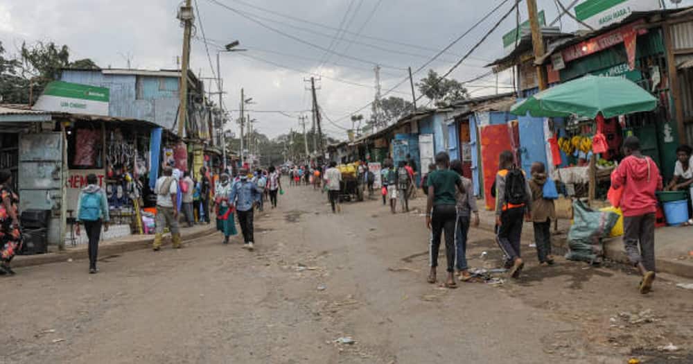 People walking in one of Nairobi's slum street.