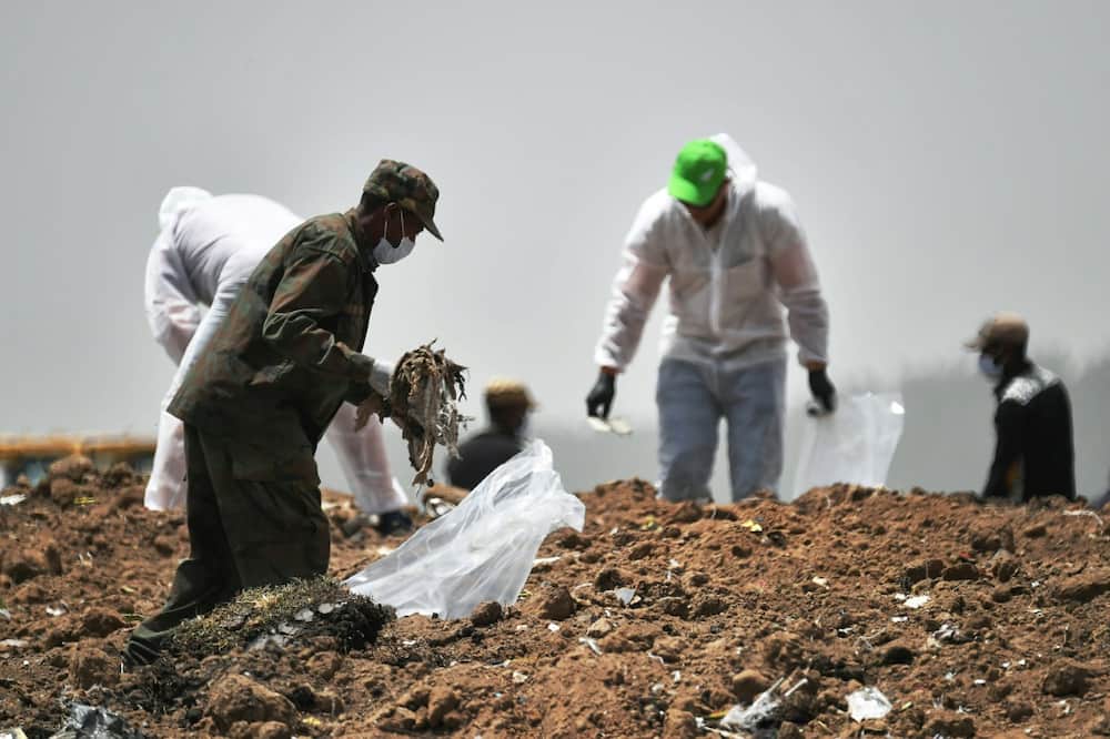 Forensics experts shown in March 2019 combing through the crash site of an Ethiopian Airlines operated Boeing 737 MAX aircraft