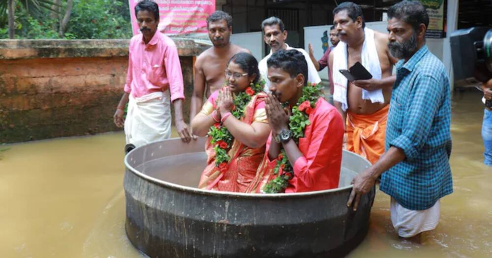 Akash Kunjumon and his bride, A. Aishwarya, in cooking a pot. Photo: The Washington Post.