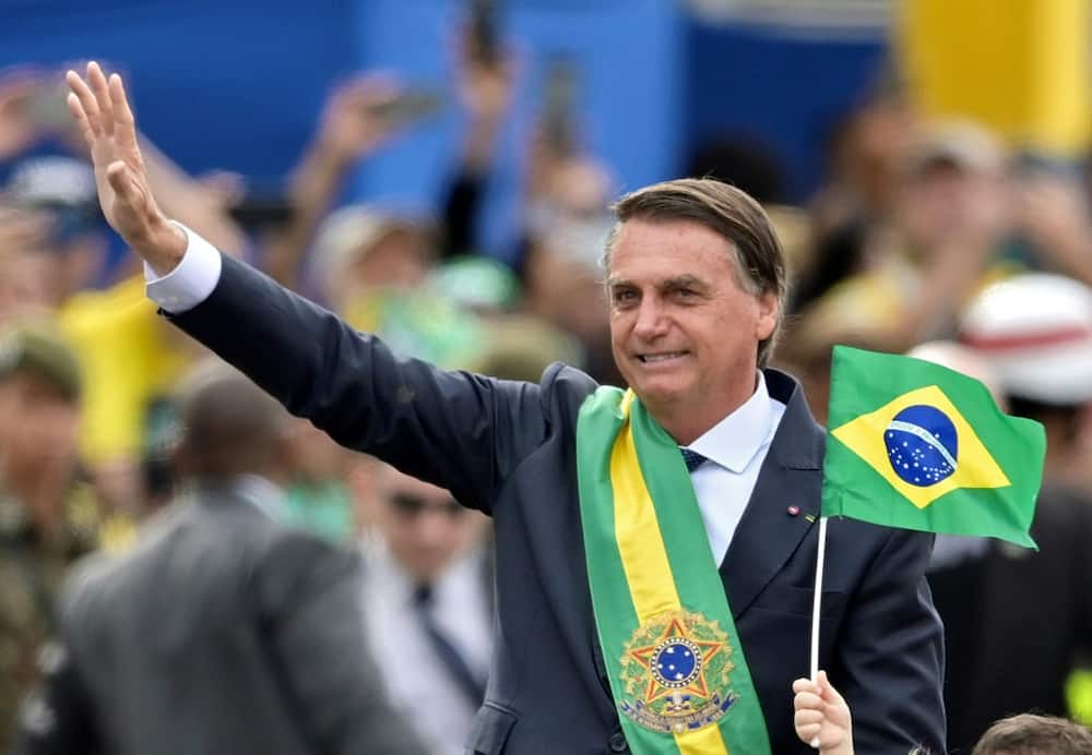 Brazilian President Jair Bolsonaro waves at the crowd during a military parade to mark Brazil's 200th anniversary of independence in Brasilia, on September 7, 2022