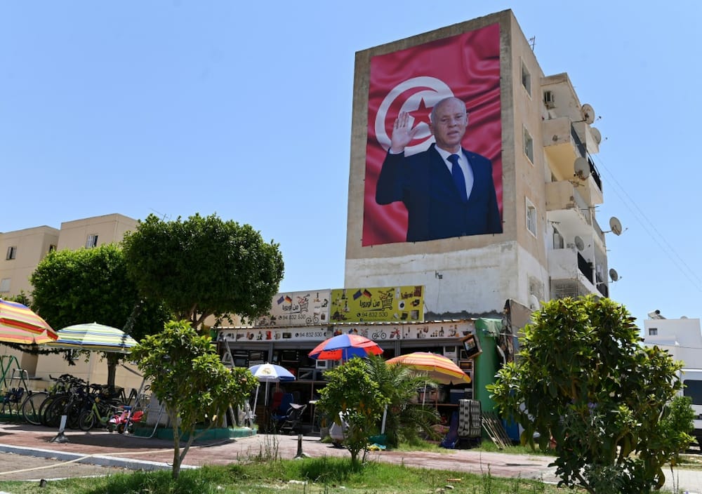 A billboard depicting Tunisia's President Kais Saied hangs on the side of a building in the central city of Kairouan, on July 26, 2022