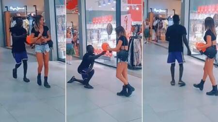 Black man goes on his knees, gifts balloon to Mzungu lady at a mall, her reaction is priceless